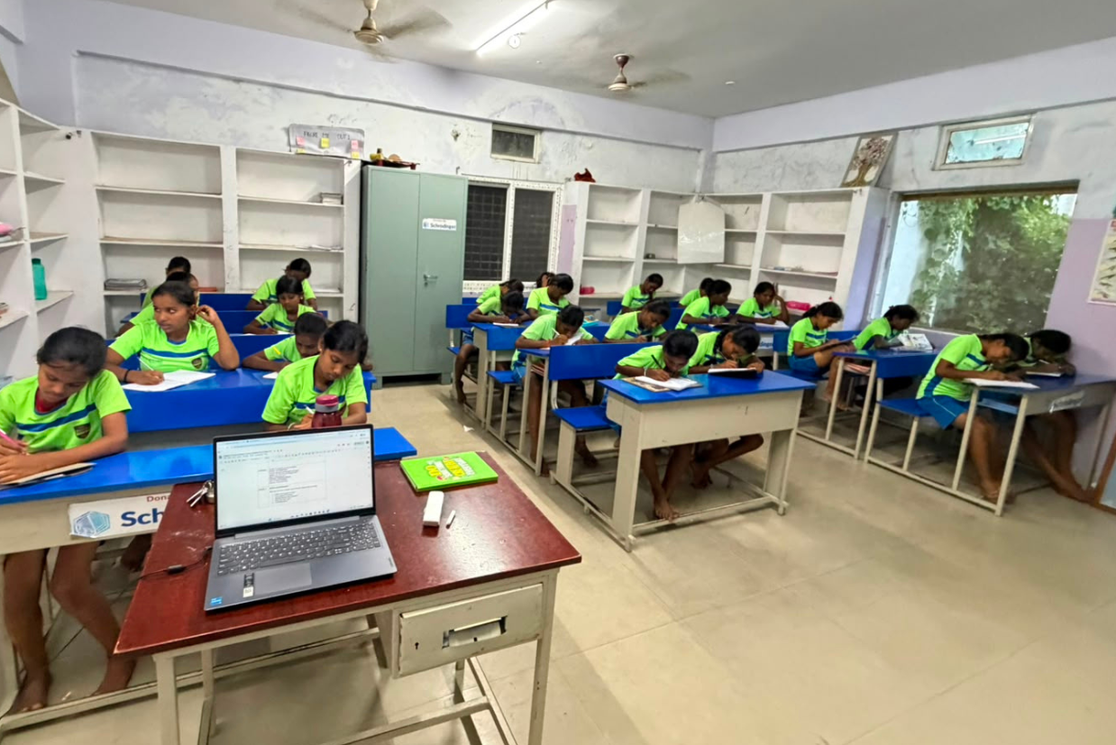 Hi 5 children in an English class with laptops