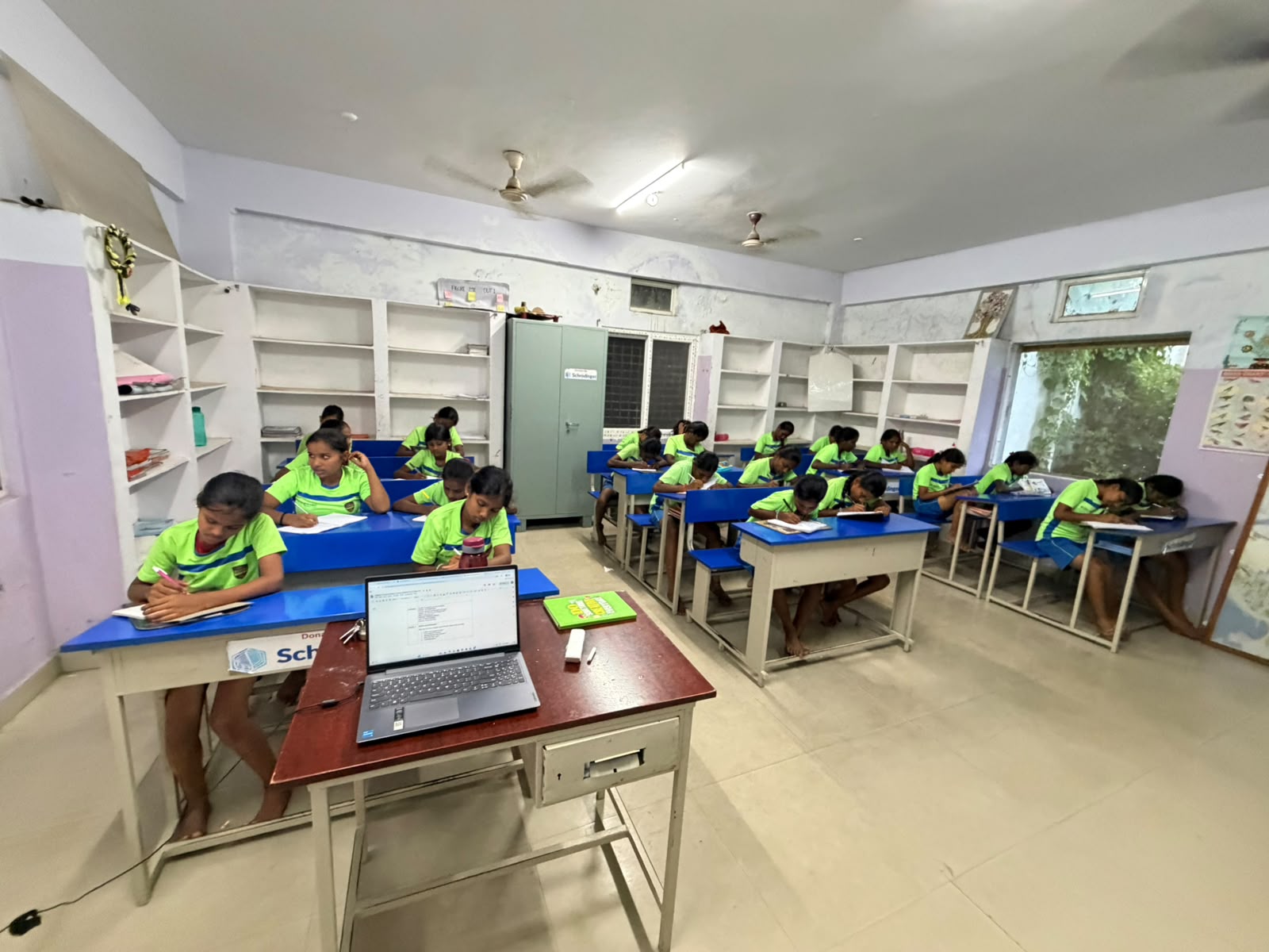Children in a Hi 5 English class with laptops